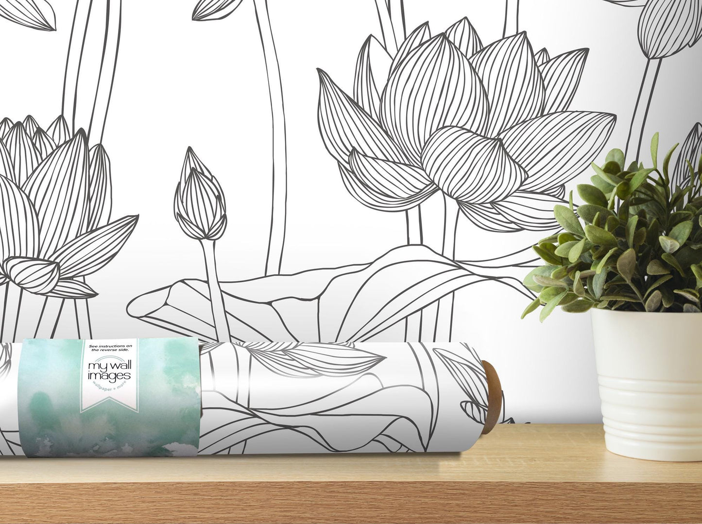 a vase with a plant on a table next to a wallpaper