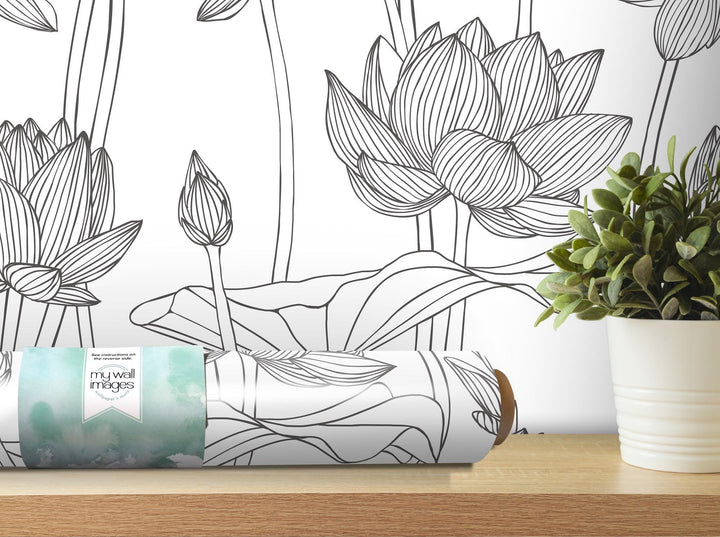 a vase with a plant on a table next to a wallpaper