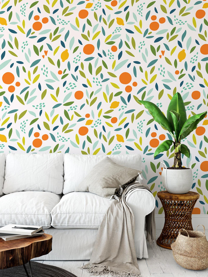 a living room with a white couch and colorful wallpaper
