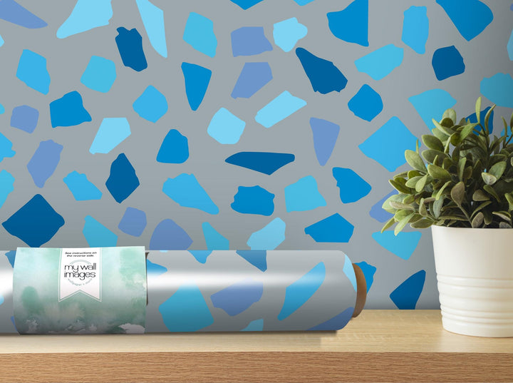 a vase with a plant on top of a table