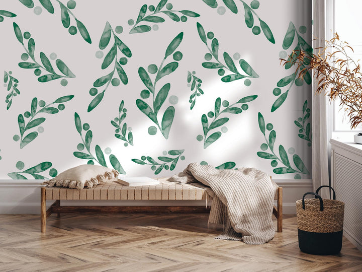 a room with a bed and a wall with green leaves on it