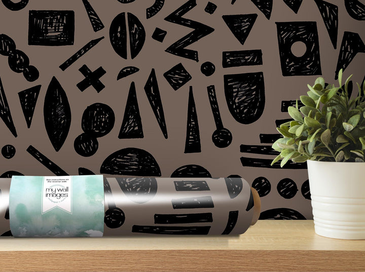 a roll of wrapping paper sitting on a table next to a potted plant