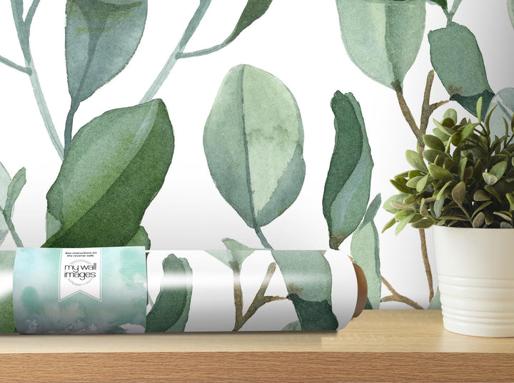 a roll of wrapping paper sitting next to a potted plant