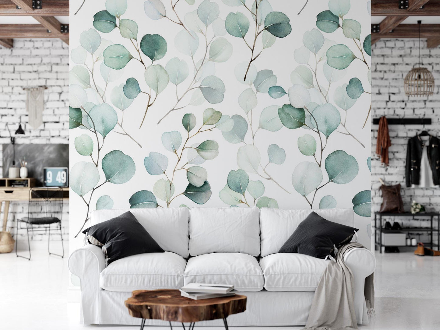 a living room with a white couch and a wall mural