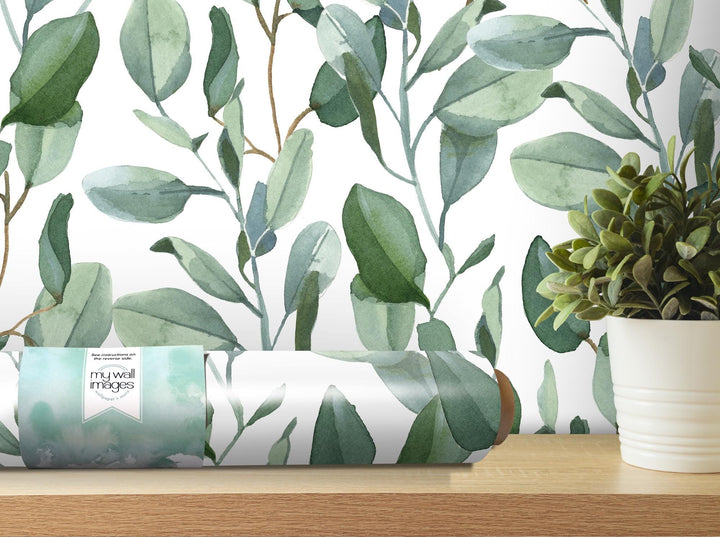 a roll of wrapping paper sitting on a table next to a potted plant