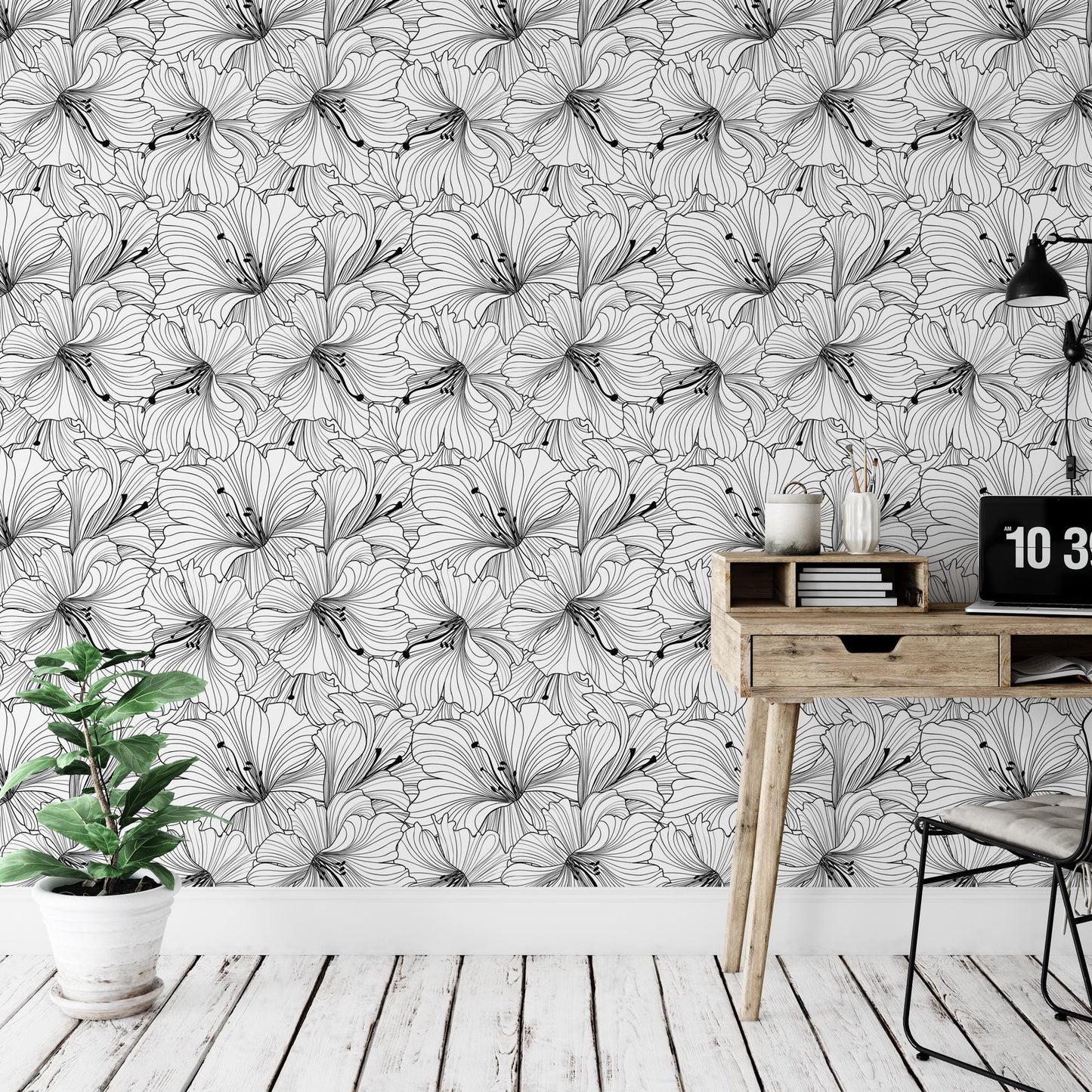 a room with a desk, chair, and wallpaper