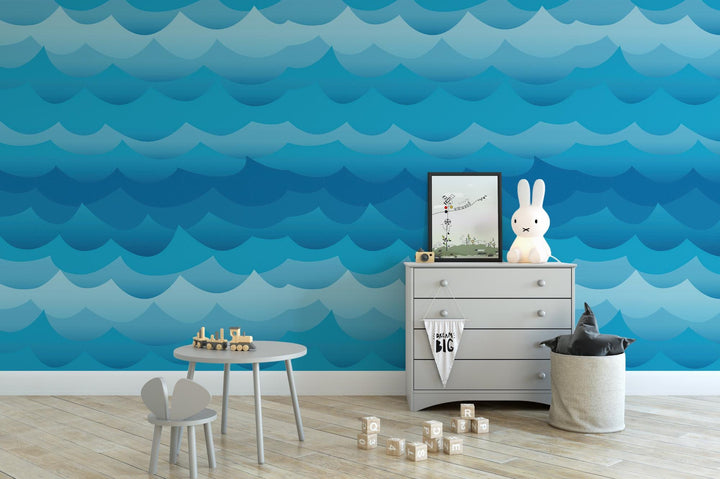 a child's room with a blue wave wallpaper