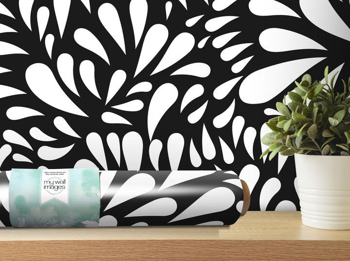 a black and white wallpaper with a plant in a vase