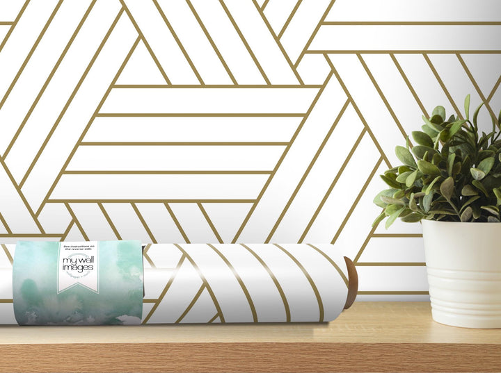 a white vase with a green plant on a table