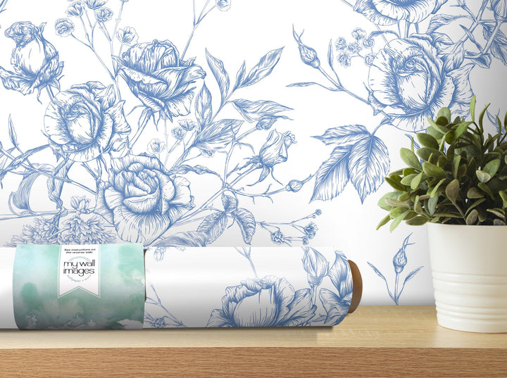 a vase of flowers and a roll of toilet paper on a table