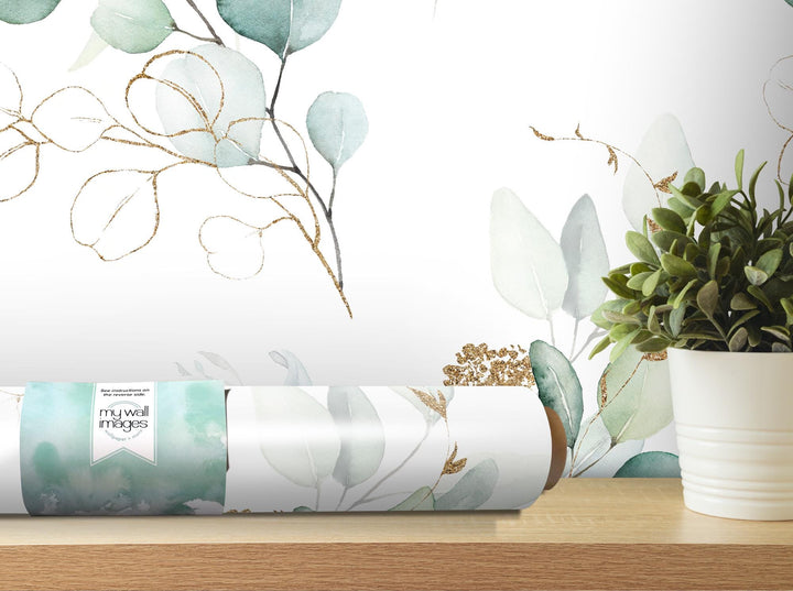 a white vase with a plant in it on a table