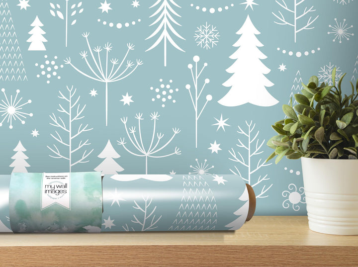 a blue wall with white trees and snowflakes on it