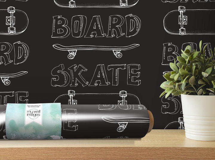 a blackboard wall with skateboards and a plant