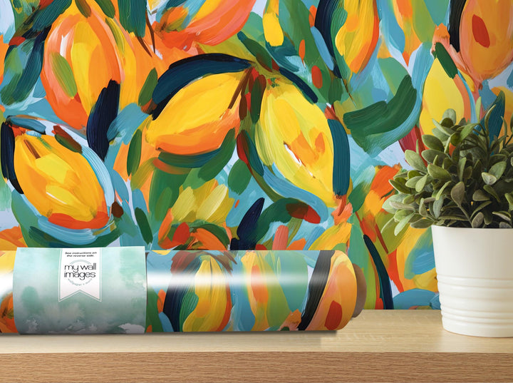 a painting of oranges on a wall next to a potted plant