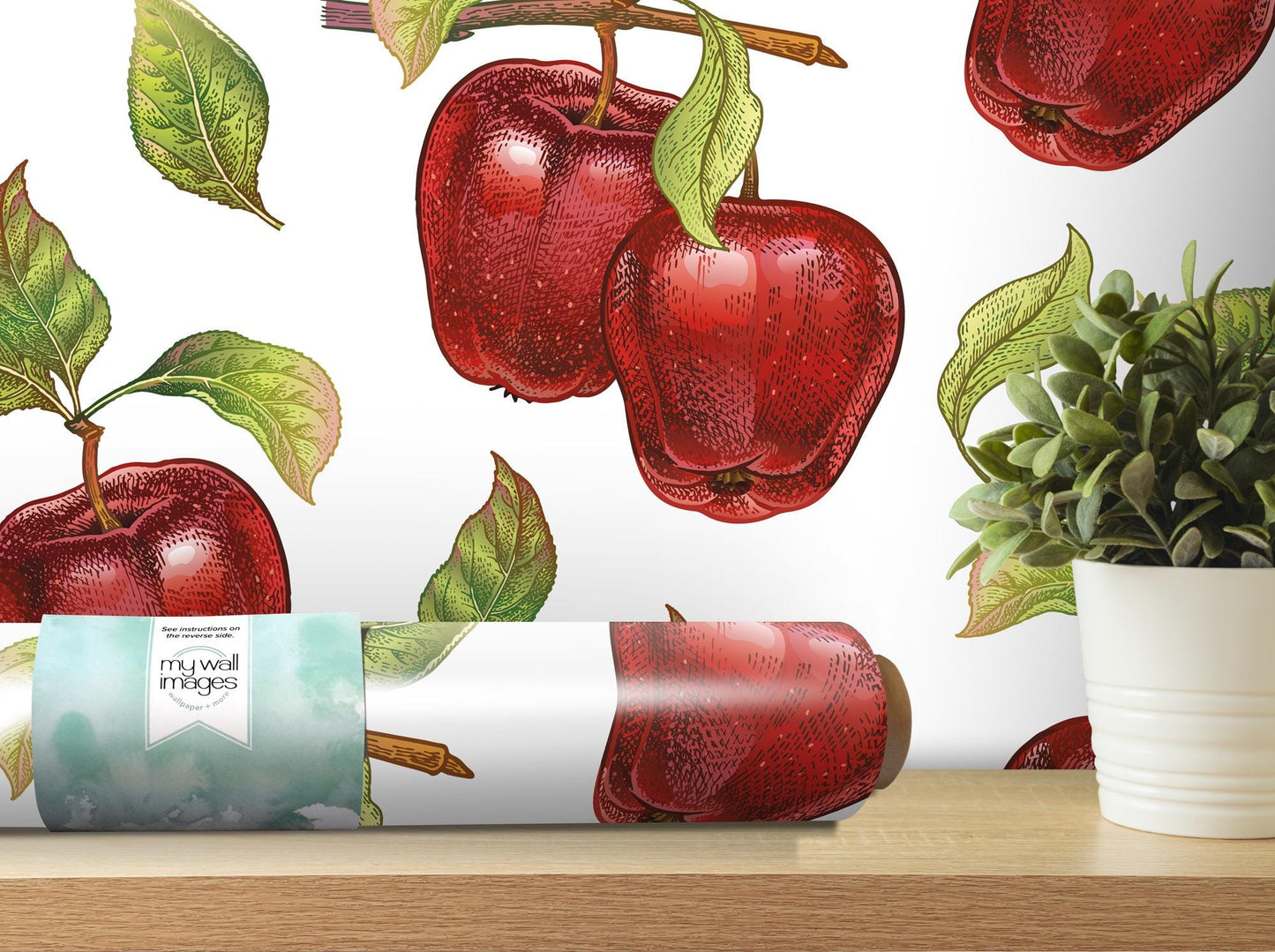 a painting of apples on a wall next to a potted plant