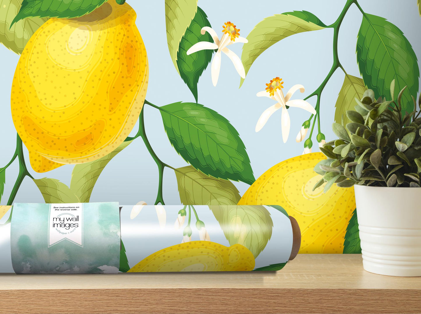 a vase with a plant and a roll of wrapping paper on a table