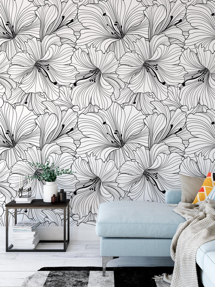 a living room with a couch and a flower wallpaper