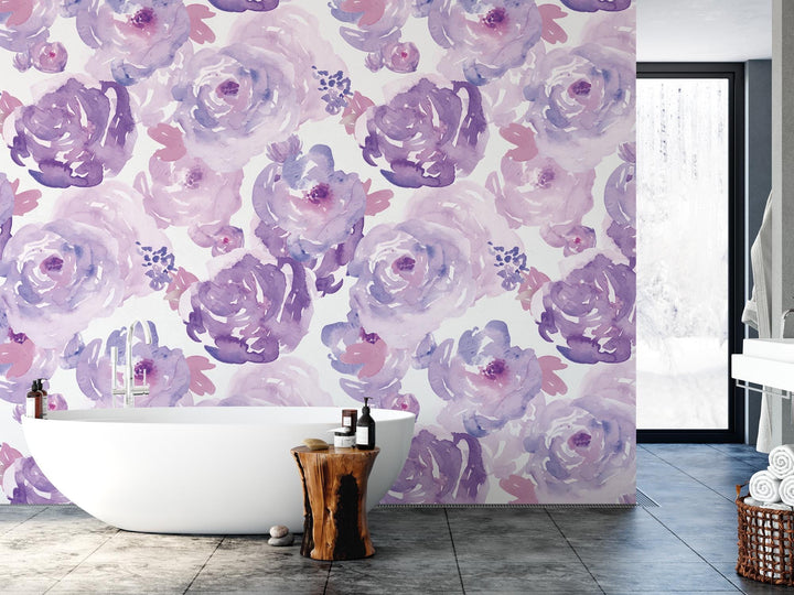 a bath tub sitting next to a wall covered in purple flowers
