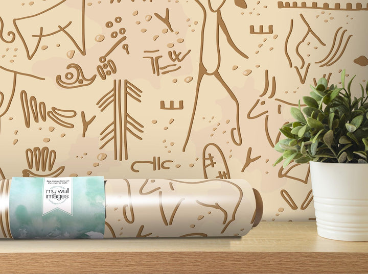 a plant is sitting on a table next to a roll of wrapping paper