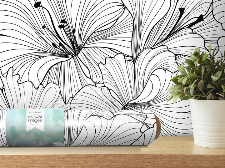 a white vase with a plant on a table