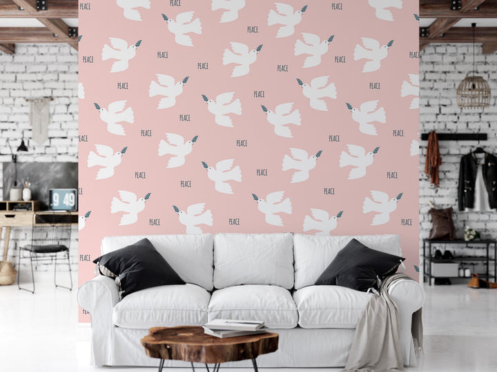 a living room with a white couch and a pink wall