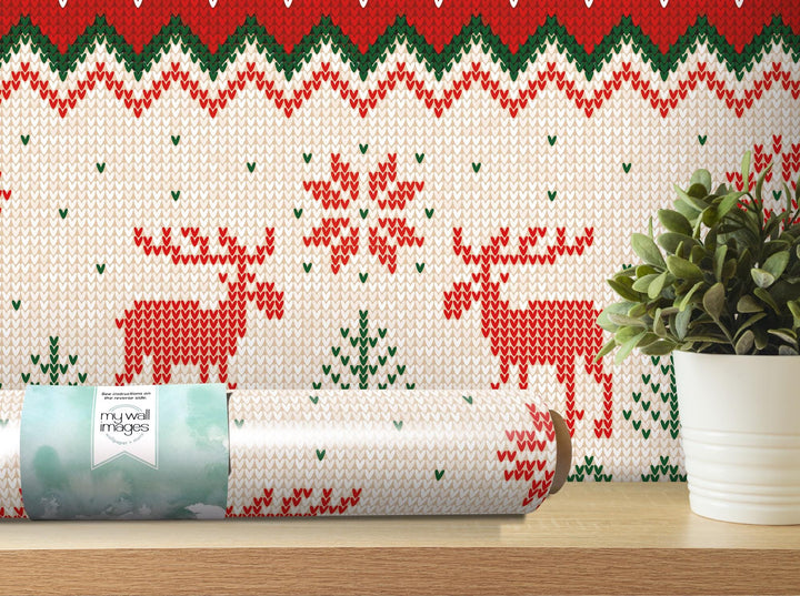 a christmas wrapping with a reindeer pattern on it