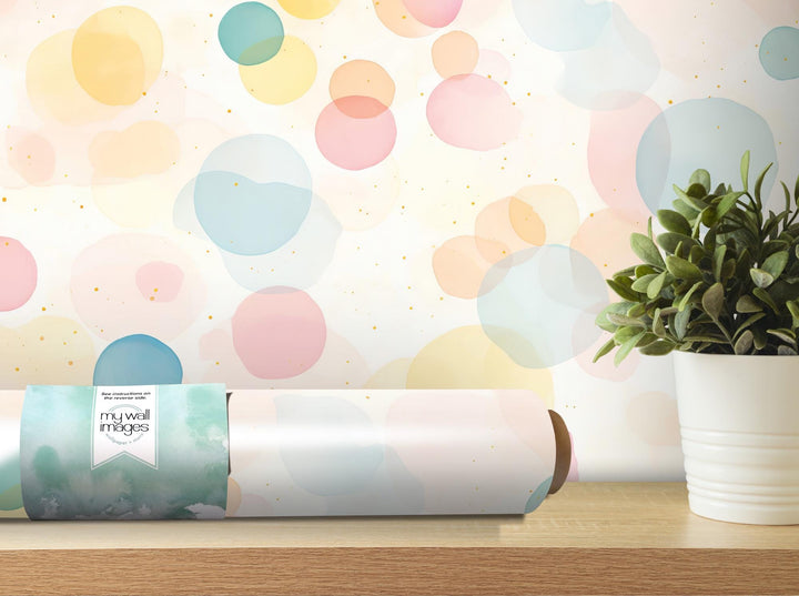 a vase with a plant on a table next to a roll of wrapping paper