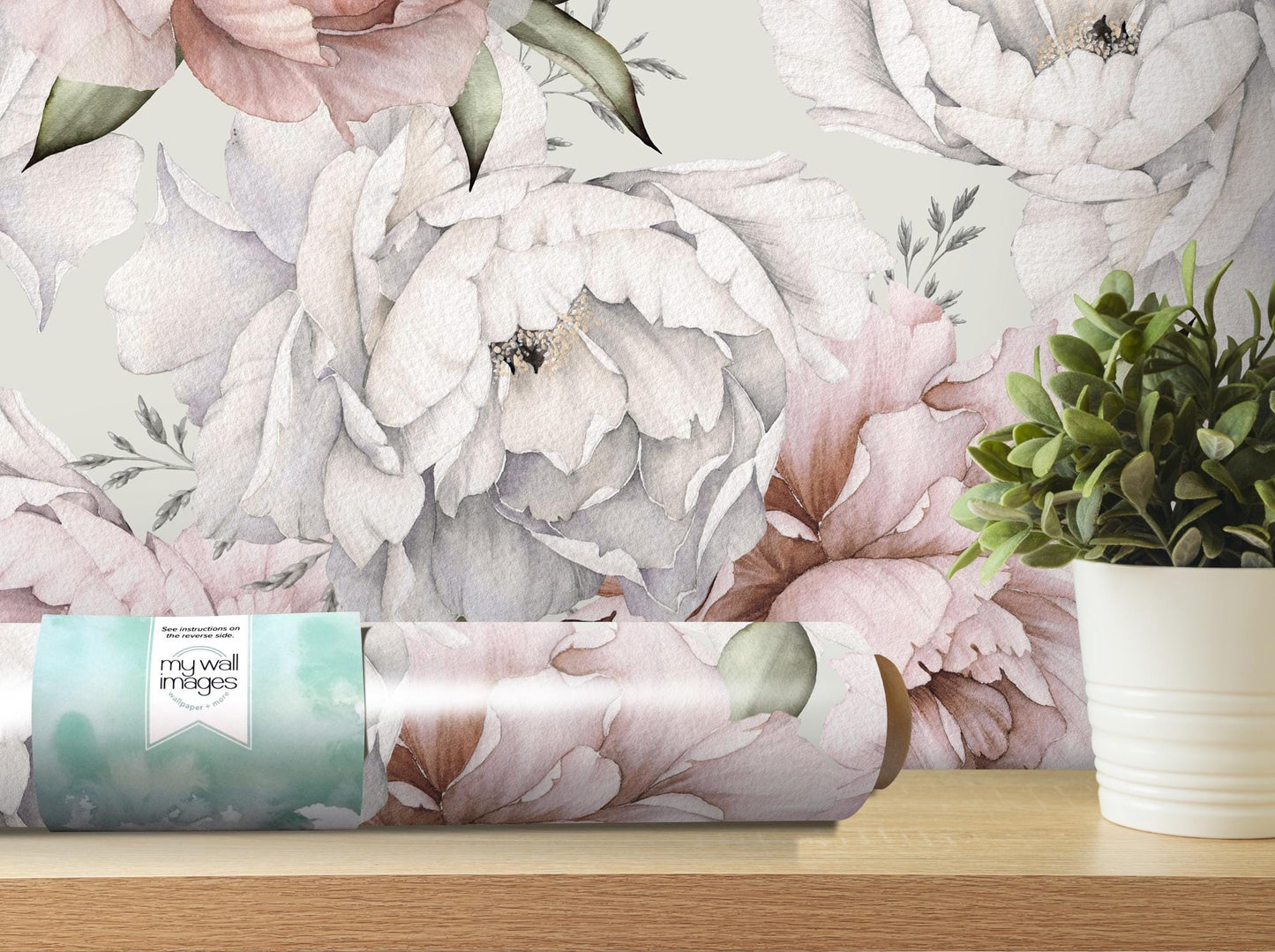 a vase of flowers and a roll of wrapping paper on a table