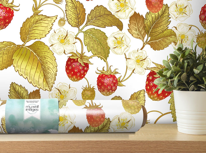 a potted plant next to a wallpaper with strawberries on it
