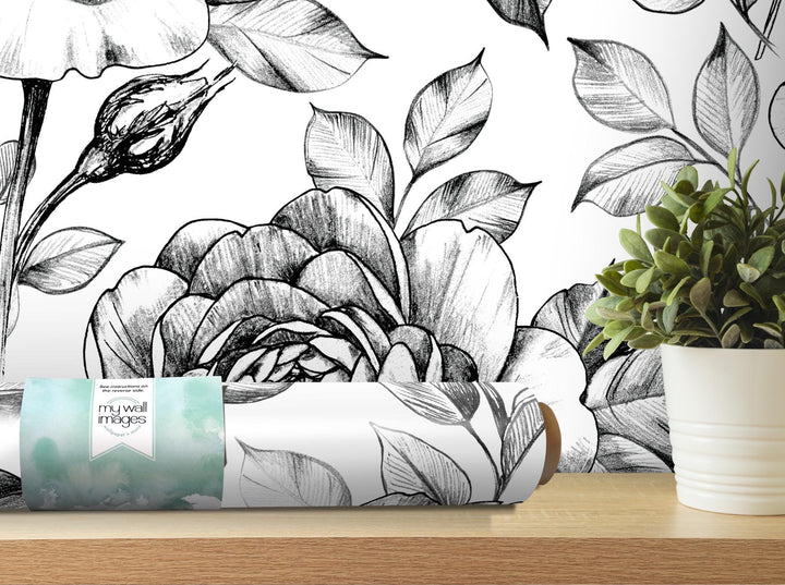 a white vase with a plant on top of a table