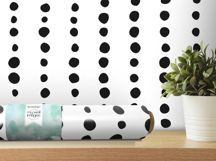 a roll of wrapping paper sitting on a table next to a potted plant