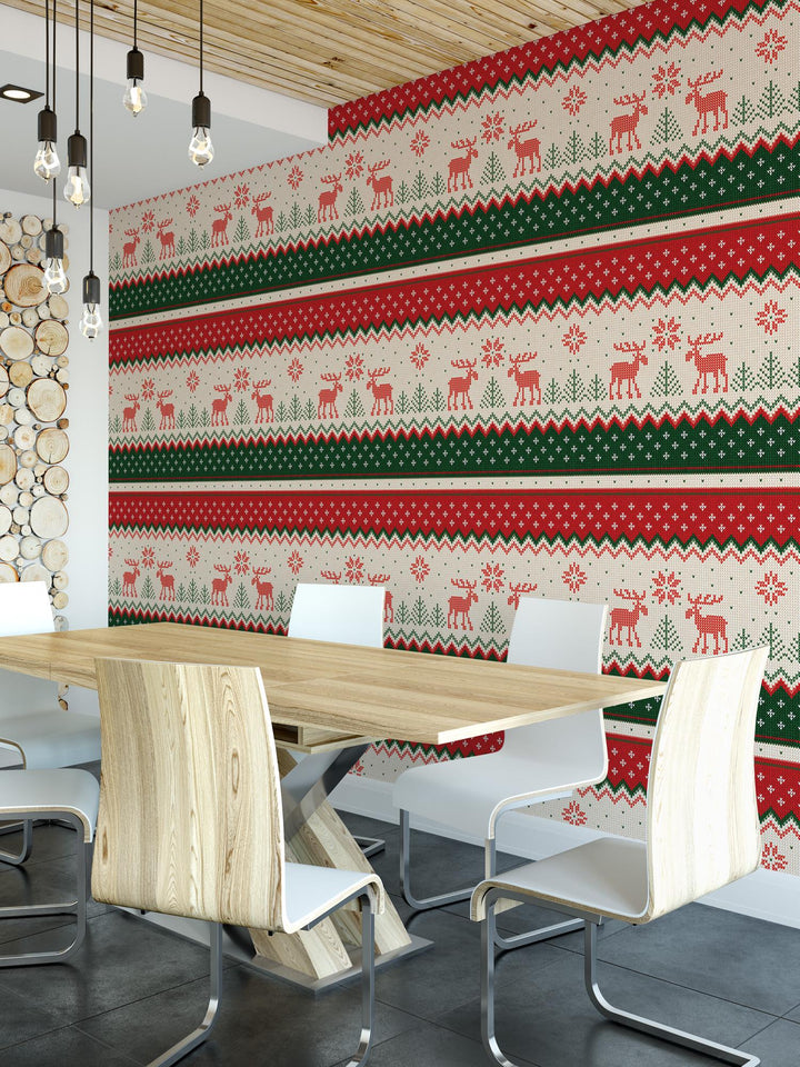 a room with a table, chairs, and a wall with a christmas themed wall