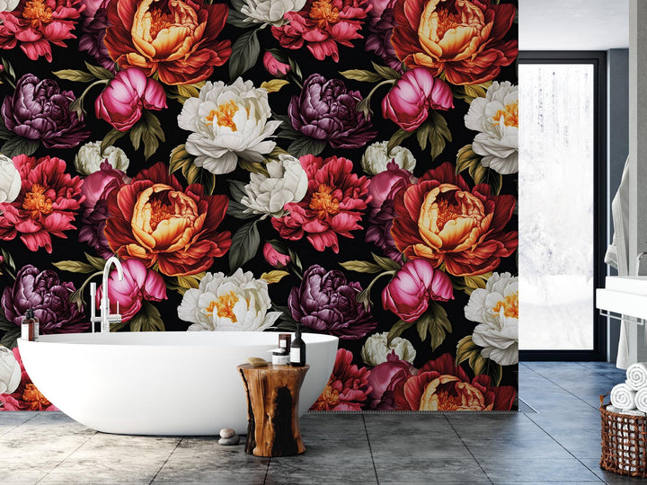 a bath tub sitting next to a wall covered in flowers