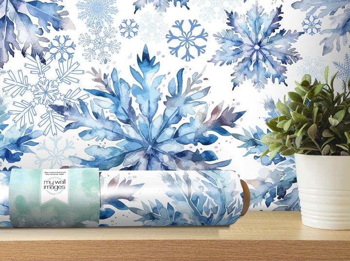 a blue and white wallpaper with snowflakes on it