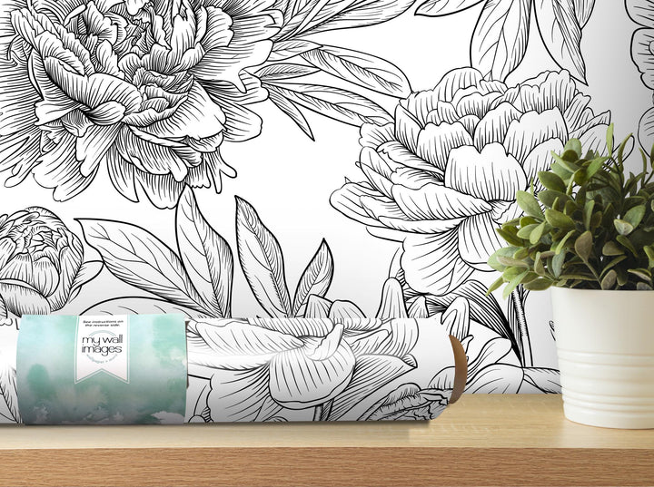 a vase with a plant and a box of tissues on a table