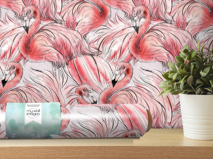 a pink flamingos wallpaper with a plant in front of it