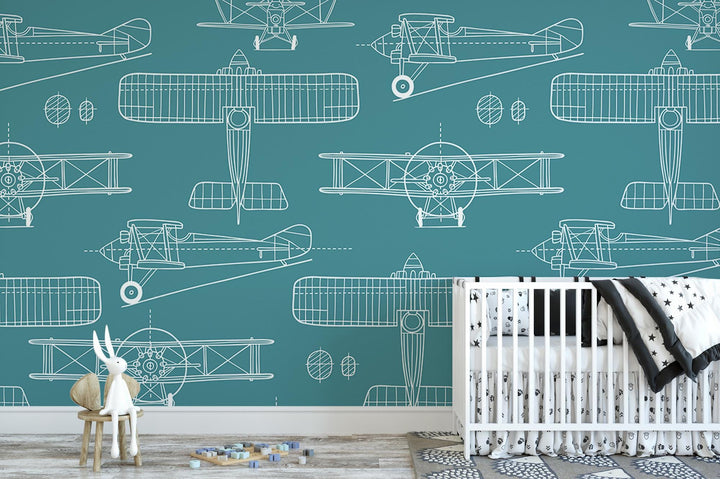 a baby's room with a crib and wallpaper with airplanes