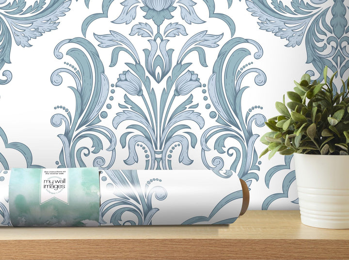 a vase with a plant on a table next to a wall paper