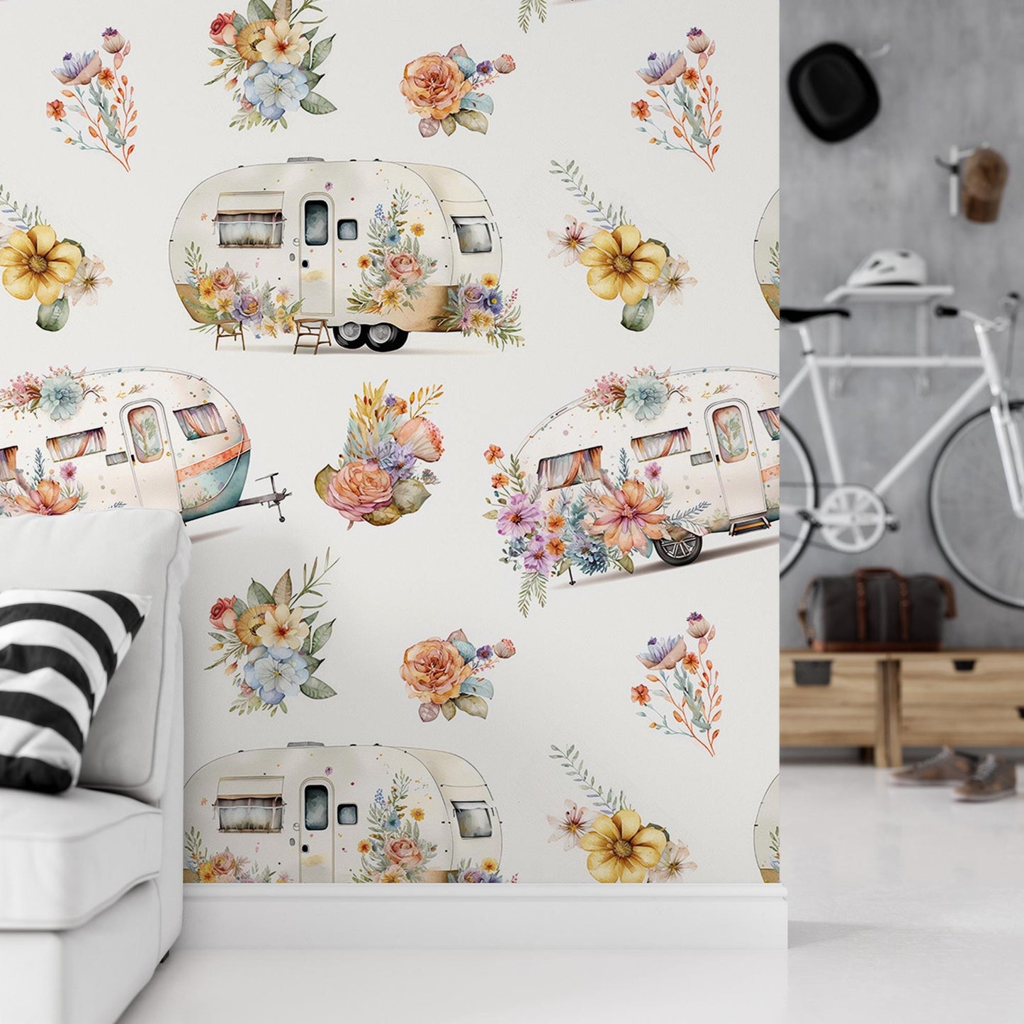 a white couch sitting next to a wall covered in flowers