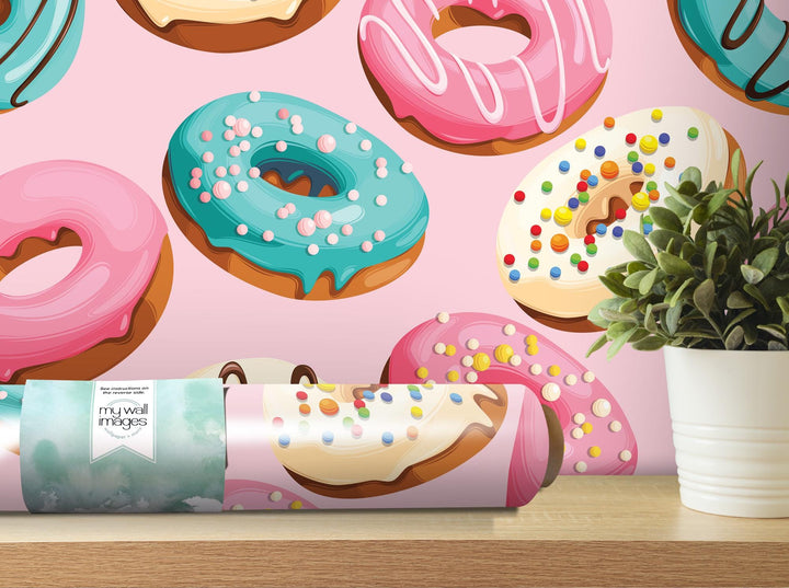 a box of doughnuts sitting on a table next to a potted plant