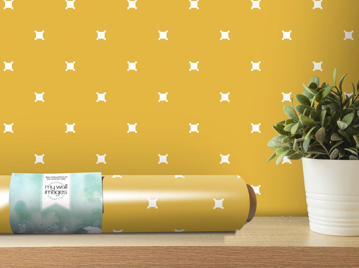 a roll of wrapping paper next to a potted plant