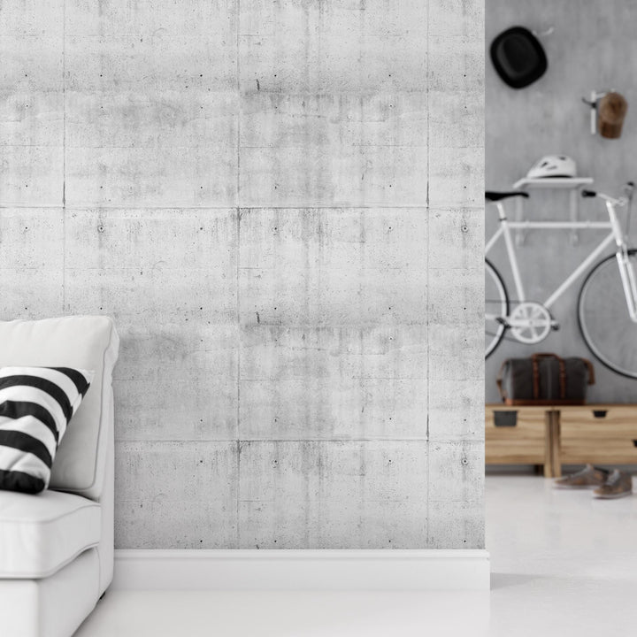 a white couch sitting in a living room next to a wall