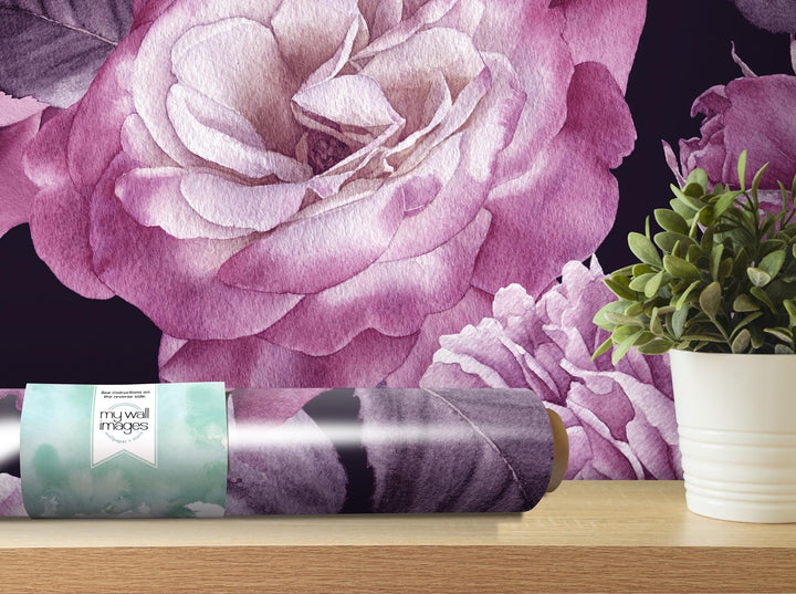 a vase of flowers next to a roll of wrapping paper