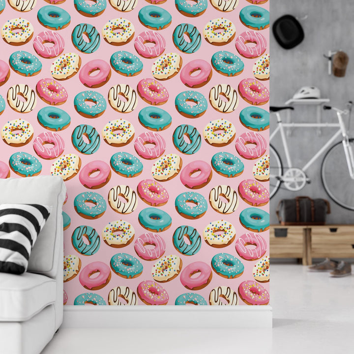 a room with a couch and a wall with a pattern of donuts on it
