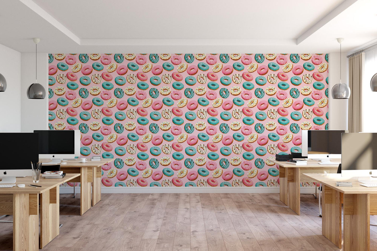 a room with multiple desks and a wall with donuts on it