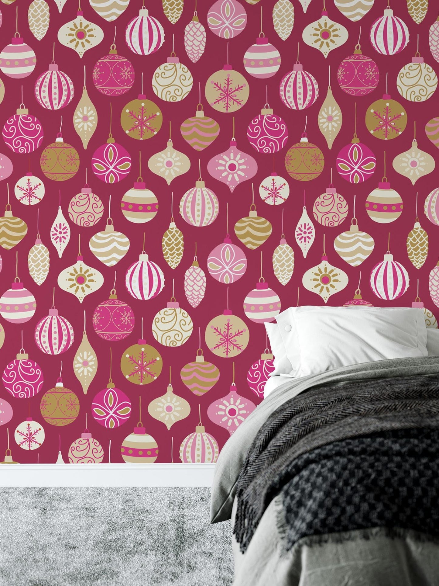 a bed sitting under a pink wall with ornaments on it
