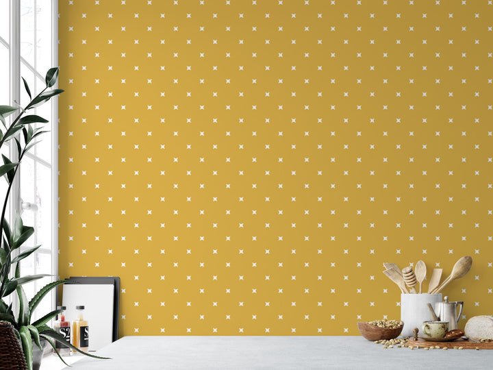 a table with a potted plant next to a yellow wall