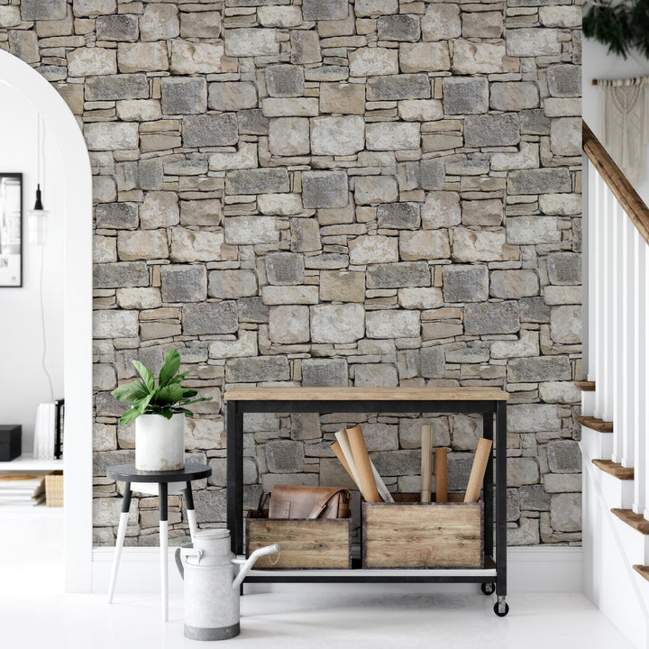 a living room with a brick wall and a potted plant