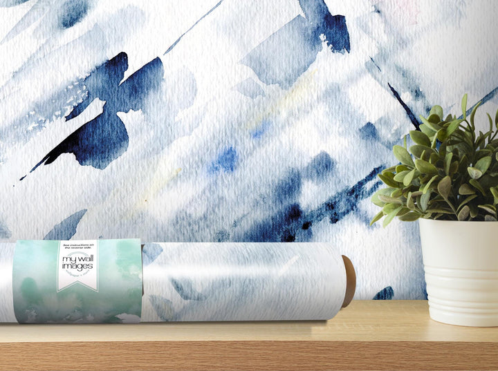 a plant is sitting on a table next to a roll of paper