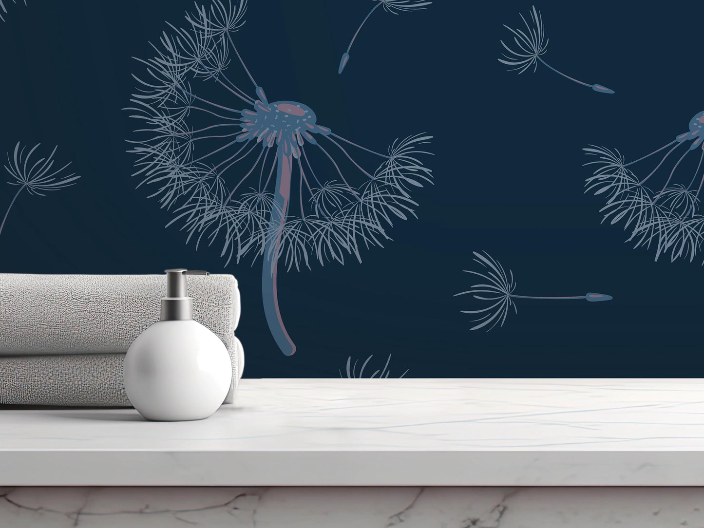 a white soap dispenser on a white marble countertop, with a folded towel and a blue dandelion-like design on the wall behind it.